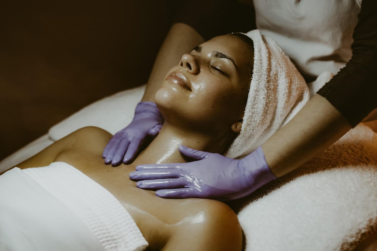 Client relaxing under a warm towel during a gentle treatment